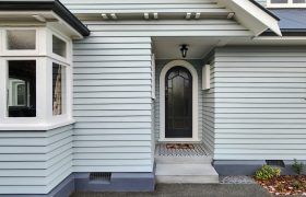 Traditional arched timber door leading from entry steps in character home, Christchurch