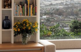 Oak window seat and built-in shelving looking out across Christchurch to the mountains beyond